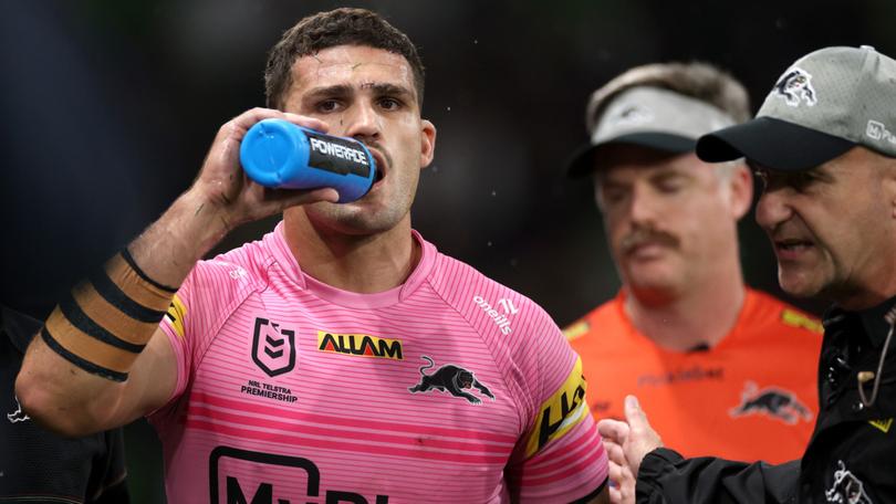 Nathan Cleary of the Panthers is assisted off the field by a trainer for a Head Injury Assessment (HIA).