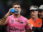 Nathan Cleary of the Panthers is assisted off the field by a trainer for a Head Injury Assessment (HIA).