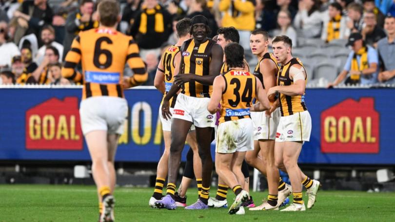 Hawthorn teammates rush to Mabior Chol after one of his three goals in the Hawks' win over Carlton. 