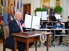 US President Donald Trump holds an executive order after signing it in the East Room of the White house in Washington, DC, March 20, 2025. 