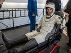 NASA astronaut Suni Williams is helped out of a SpaceX Dragon spacecraft.