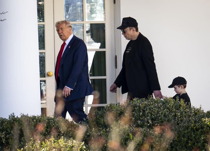 President Donald Trump walks with Elon Musk and  his son X AE A-Xii.