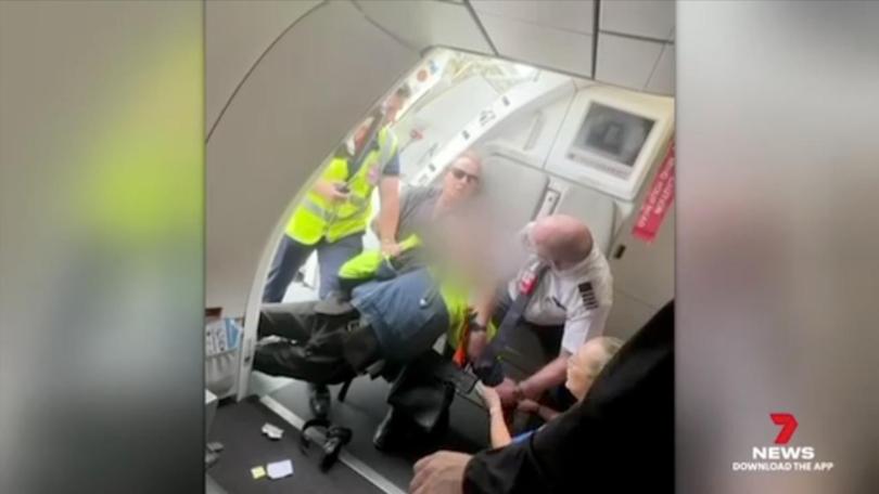 The teenager was tackled and arrested after allegedly carrying a gun onto a plane. 