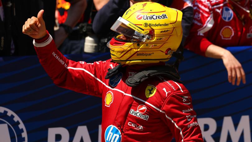 Sprint winner Lewis Hamilton celebrates in parc ferme after his first win for Ferrari.