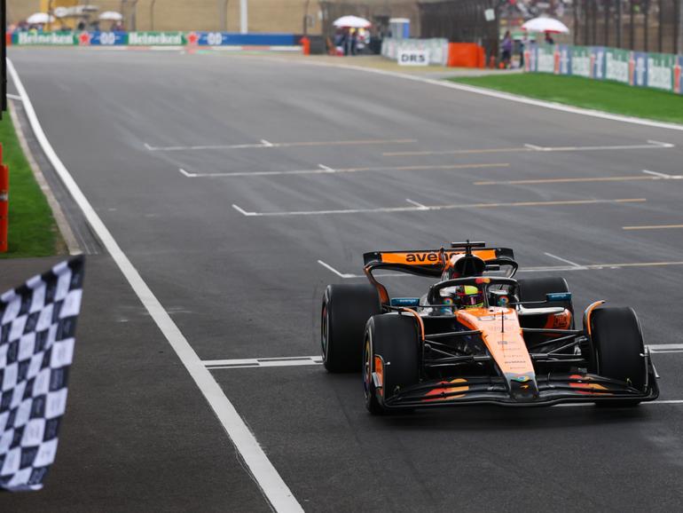 Race winner Oscar Piastri of Australia driving the (81) McLaren MCL39 Mercedes takes the chequered flag.