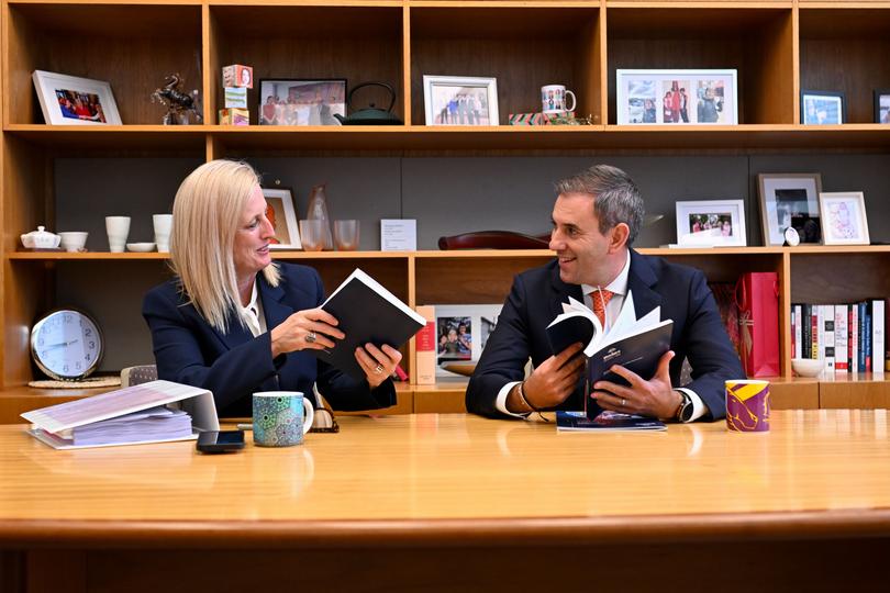 Australian Treasurer Jim Chalmers (right) and Australian Finance Minister Katy Gallagher take a look at the Budget papers.