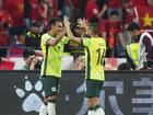 Nishan Velupillay (l) is congratulated on scoring Australia's second goal in China by Aziz Behich. 