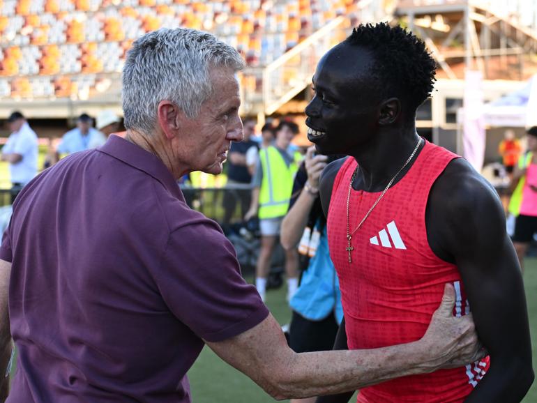 Bruce McAvaney and Gout Gout embrace after the Men 200m Under 20 Final during the Queensland Athletics Championships.