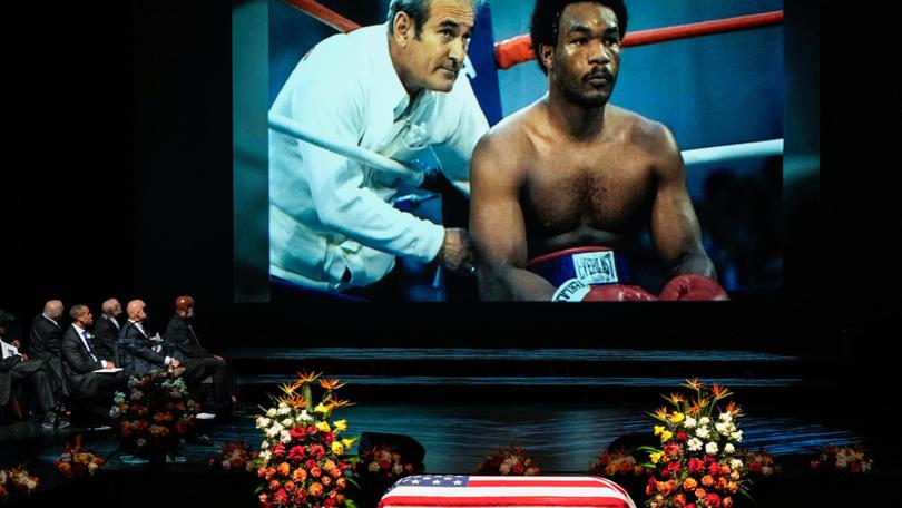 A photo of George Foreman sitting in the corner of a boxing ring is shown during a tribute video honoring Olympic and world champion boxer and minister Foreman during his memorial service at Wortham Theater Center in Houston, Monday, April 14, 2025. (Brett Coomer/Houston Chronicle via AP) Brett Coomer