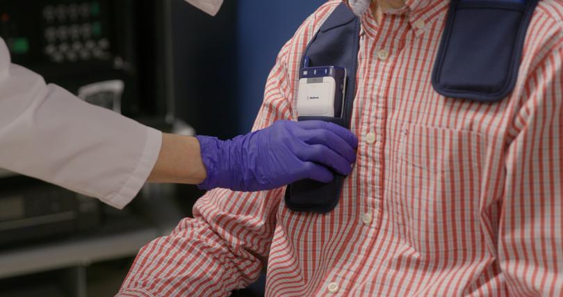 Bronte-Stewart connects a programming device to Krehbiel's implanted neurostimulator.