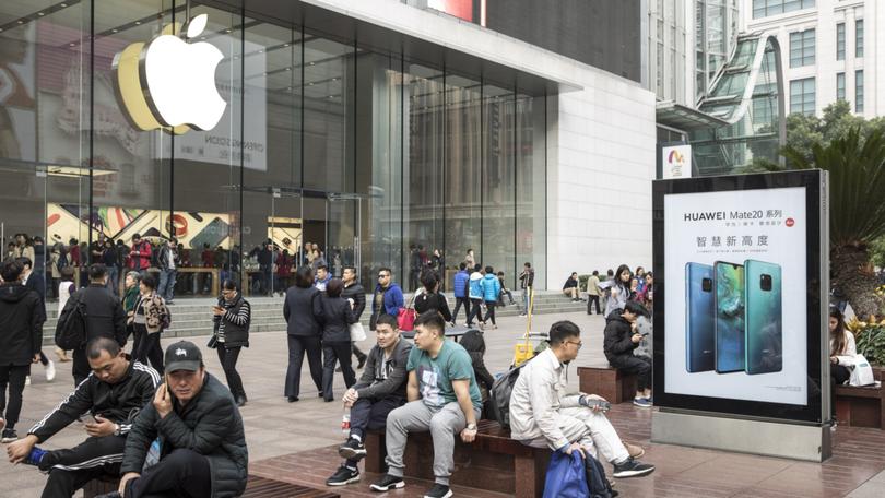 A Huawei ad outside an Apple store in Shanghai. 