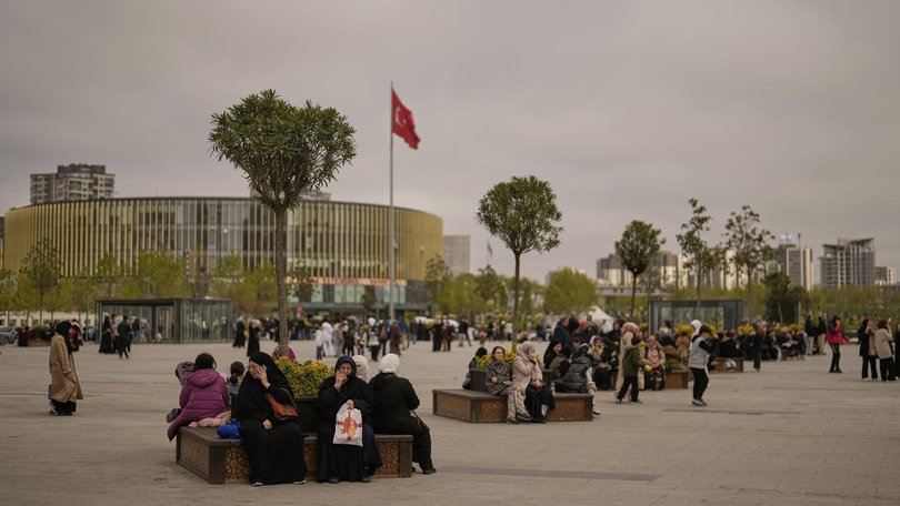People gathered outdoors in Istanbul as aftershocks continued to be felt following a strong quake. (AP PHOTO)
