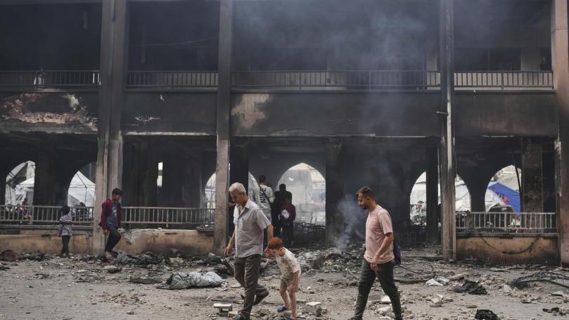 At least 10 people were killed in an Israeli strike on a school sheltering families, medics say.