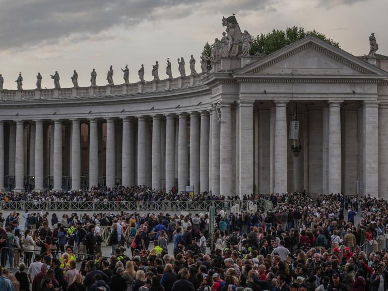 Faithful join a long line into St Peter's Square to view the body of Pope Francis laying in state inside St Peter's Basilica.
