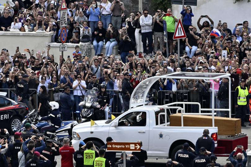 VATICAN CITY, VATICAN - APRIL 26: People gather along the road as the coffin of late Pope Francis is transported from St Peter's Basilica to Santa Maria Maggiore Basilica during the funeral of Pope Francis in St. Peter’s Square on April 26, 2025 in Vatican City, Vatican. Pope Francis died on April 21st at the age of 88. Born in Argentina as Jorge Mario Bergoglio, he was the first Latin American and the first Jesuit to become Pope when elected in 2013. Taking the name Francis after St Francis of Assisi, he promoted a more humble version of the papacy than many of his predecessors. He will be buried outside of the Vatican in a simple wooden coffin at the Basilica Santa Maria Maggiore. (Photo by Antonio Masiello/Getty Images)