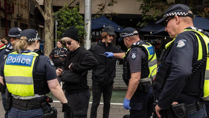 Members of Victoria Police search pro-trans activists. Picture: NewsWire / Diego Fedele
