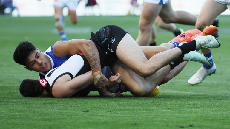 Josh Sinn of the Power is tackled by Paul Curtis.