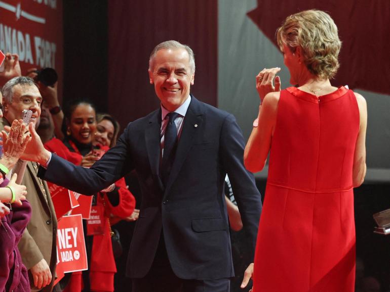 Canada's Prime Minister and Liberal Party leader Mark Carney and his wife Diana Fox Carney greet supporters at a victory party in Ottawa.