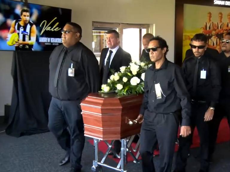 Andrew Krakouer's casket is carried at his funeral service. 