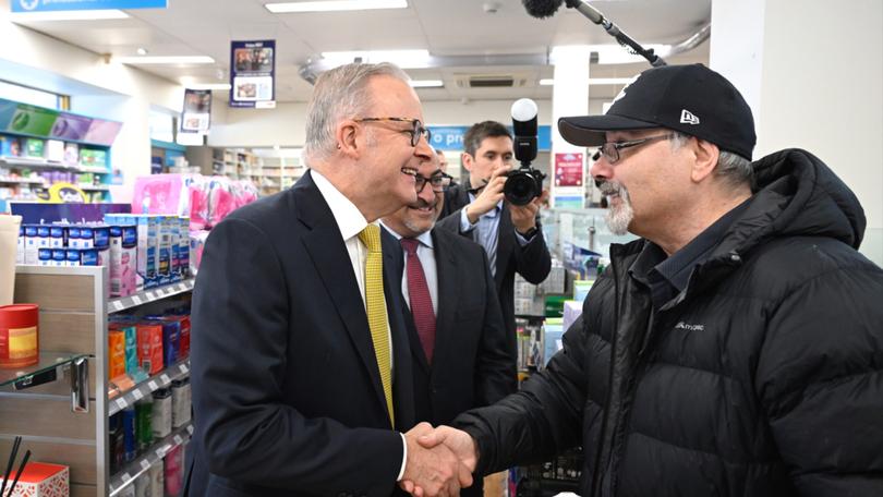 Anthony Albanese speaks to a local as he visits Bell Street Pharmacy with Peter Khalil.