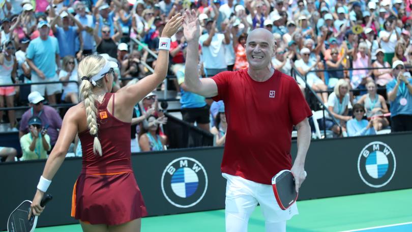Andre Agassi high-fives mixed partner Anna Leigh Waters after a point won against Tristan Dussault and Stevie Petropouleas during the 2025 US Open Pickleball Championships Pro Mixed Doubles round of 16.