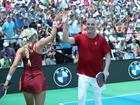 Andre Agassi high-fives mixed partner Anna Leigh Waters after a point won against Tristan Dussault and Stevie Petropouleas during the 2025 US Open Pickleball Championships Pro Mixed Doubles round of 16.