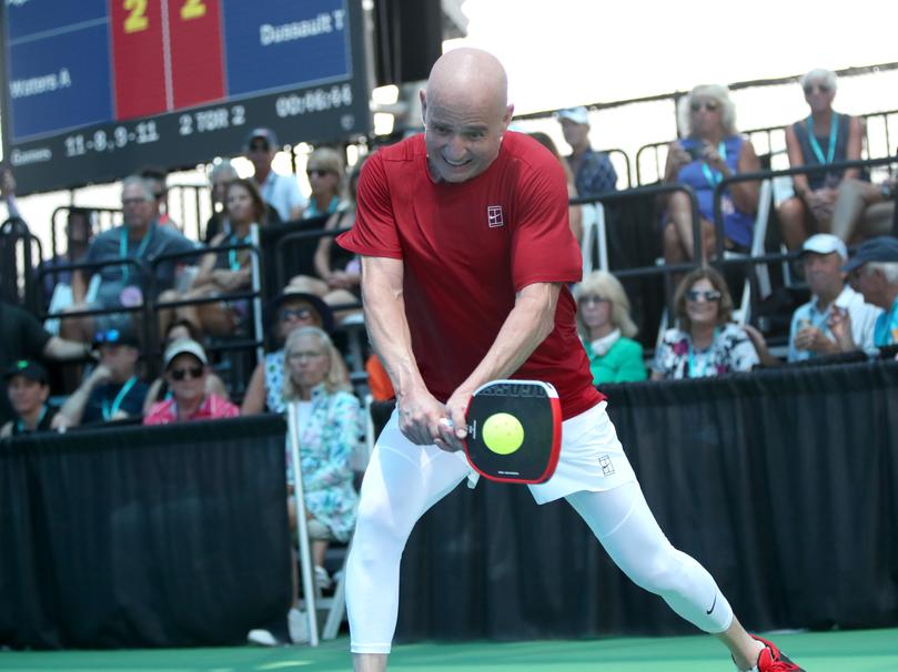 Andre Agassi hits a backhand drive shot.
