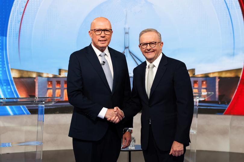 Opposition Leader Peter Dutton and Prime Minister Anthony Albanese pose for photos ahead of the third leaders' debate in Sydbey on Tuesday 22 April. 