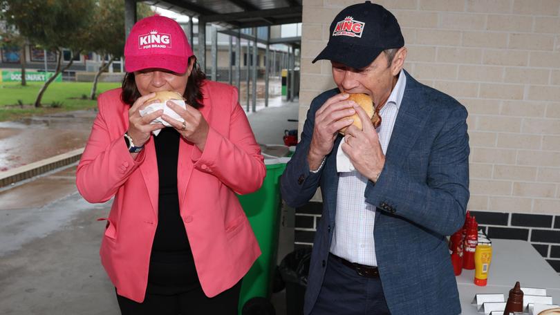 Resources Minister Madeleine King and Premier Roger Cook tuck into a bacon and eggs roll each after voting at Wellard Primary School this morning.