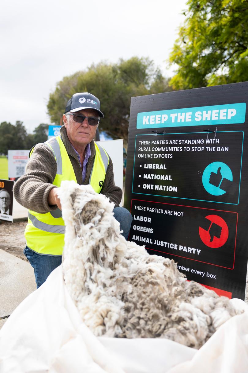 Derek Curwin, a farmer from Albany poses for a photo with his stocks wool and with 'Keep the Sheep' campaign signage on May 03, 2025 in Perth, Australia. 