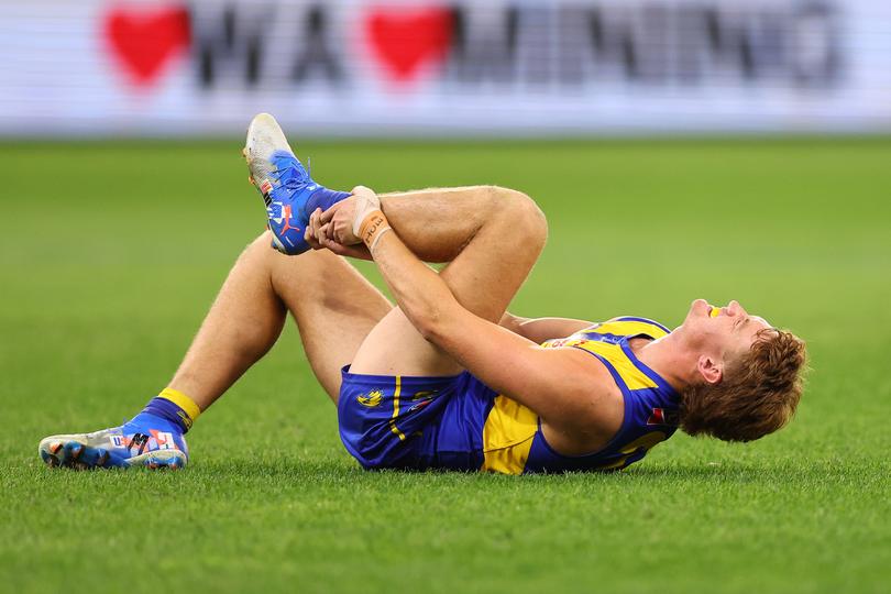 PERTH, AUSTRALIA - MAY 03: Archer Reid of the Eagles holds his lower left leg after an injury during the round eight AFL match between West Coast Eagles and Melbourne Demons at Optus Stadium, on May 03, 2025, in Perth, Australia. (Photo by Paul Kane/Getty Images via AFL Photos)