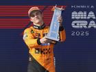 Drivers' championship leader Oscar Piastri raises the trophy after his dominant win in the Miami.