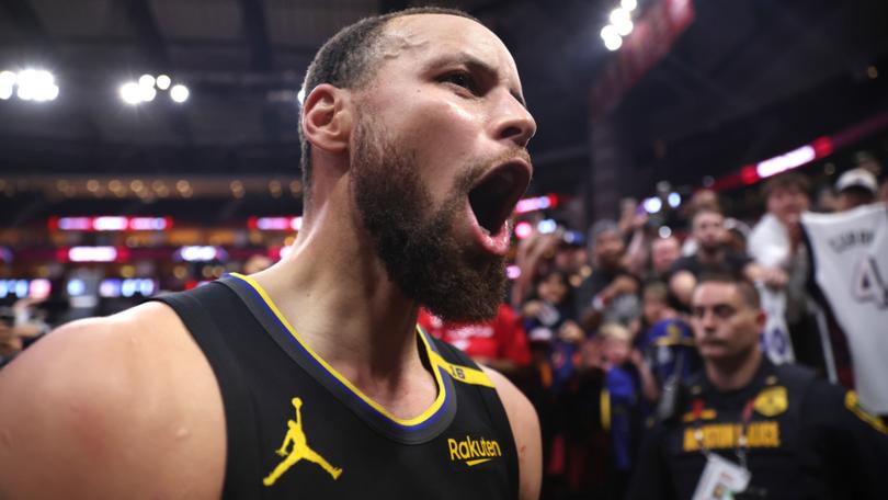 Stephen Curry celebrates after Golden State beat the Rockets.