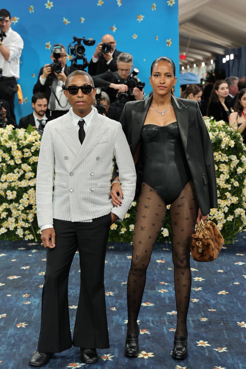 NEW YORK, NEW YORK - MAY 05: (L-R) Pharrell Williams, Met Gala Co-Chair, and Helen Lasichanh attend the 2025 Met Gala Celebrating "Superfine: Tailoring Black Style" at Metropolitan Museum of Art on May 05, 2025 in New York City. (Photo by Savion Washington/Getty Images)