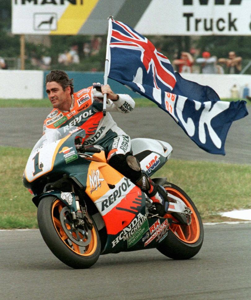 Mick Doohan celebrates his victory in the 500cc British Motorcycle Grand Prix in 1997.