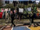 FILE —  Police patrol next to clotheslines in Tibu, a small town near the border with Venezuela, in Colombia, Jan. 22, 2025. People displaced by violence in the region had taken shelter in the town. (Federico Rios/The New York Times)