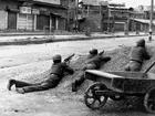 This photograph taken in 1989 shows Indian policemen taking positions after Kashmiri militants opened fire on government forces in the old city area of Naid Kadal in Srinagar. 