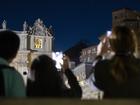 Faithful gathered in St. Peter's Square watch black smoke ouring out of the chimney atop the Sistine Chapel on the first day of the conclave to elect a new pope.