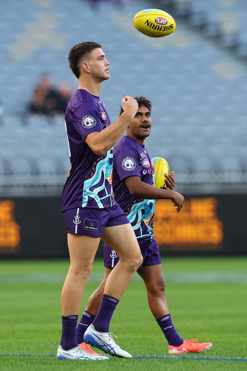 PERTH, AUSTRALIA - MAY 08: Patrick Voss and Isaiah Dudley of the Dockers walk the field before the warm up session during the round nine AFL match between Fremantle Dockers and Collingwood Magpies at Optus Stadium, on May 08, 2025, in Perth, Australia. (Photo by Paul Kane/Getty Images)