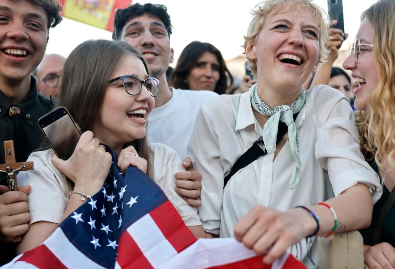 A Polish woman who lives in the United States celebrates with her Polish friends after the newly elected Pontiff, Pope Leo XIV spoke for the first time from the Vatican balcony.