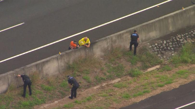 Police search for shell casings on the Bruce Highway, but find no evidence.