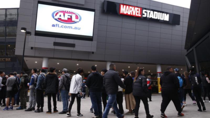 A teenage boy has been given a caution after trying to take a knife and fake gun into an AFL game.