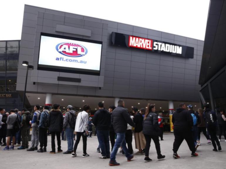 A teenage boy has been given a caution after trying to take a knife and fake gun into an AFL game.