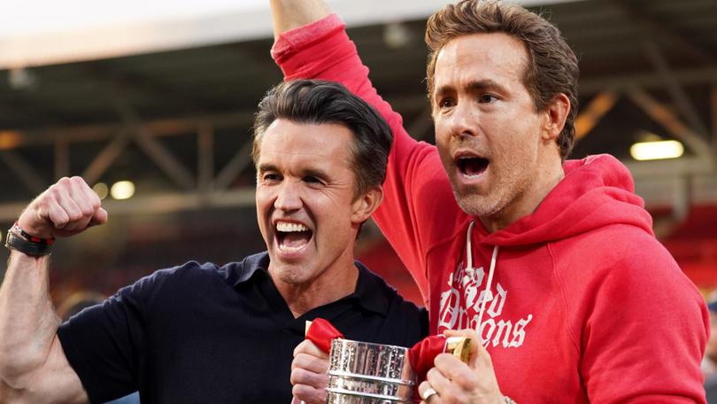 Wrexham AFC owners Rob McElhenney and Ryan Reynolds celebrate the club's latest promotion last month.