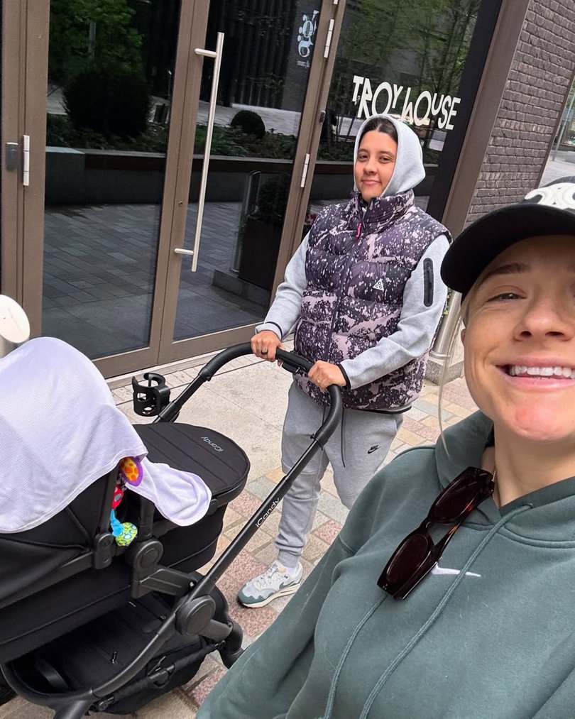 Kristie Mewis and Sam Kerr take Jagger for a walk in the stroller.