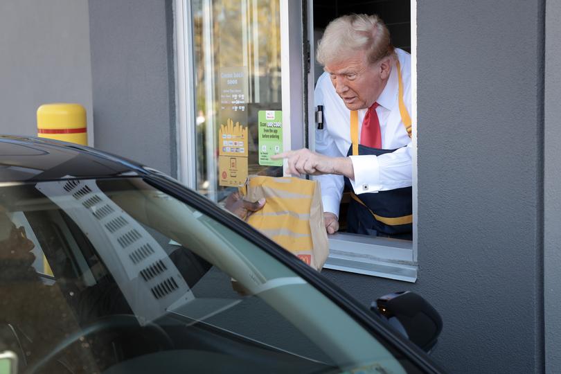 US President Donald Trump works the drive-through line as he visits a McDonald's restaurant in Pennsylvania.