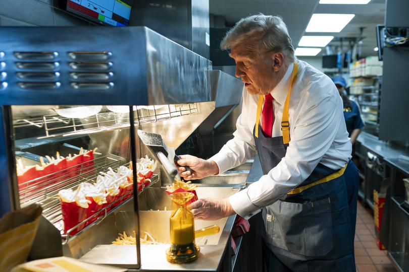 US President Donald Trump works behind the counter during a visit to McDonald’s in Pennsylvania.