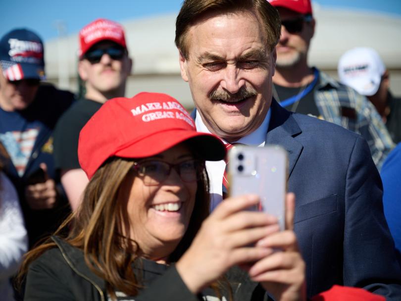 Mike Lindell, chief executive officer of MyPillow takes photos with Trump supporters at a campaign event in Waukesha, Wisconsin, on May 1, 2024.