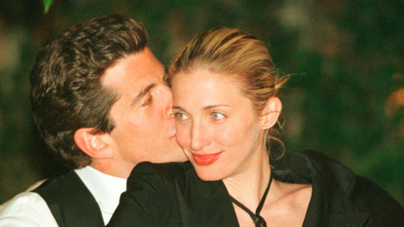 John F. Kennedy, Jr. editor of George magazine, gives his wife Carolyn Bessette Kennedy a kiss on the cheek during the annual White House Correspondents dinner May 1, 1999 in Washington, D.C.