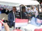 Prime Minister Anthony Albanese rides on a golf cart with Indonesian President Prabowo Subianto.